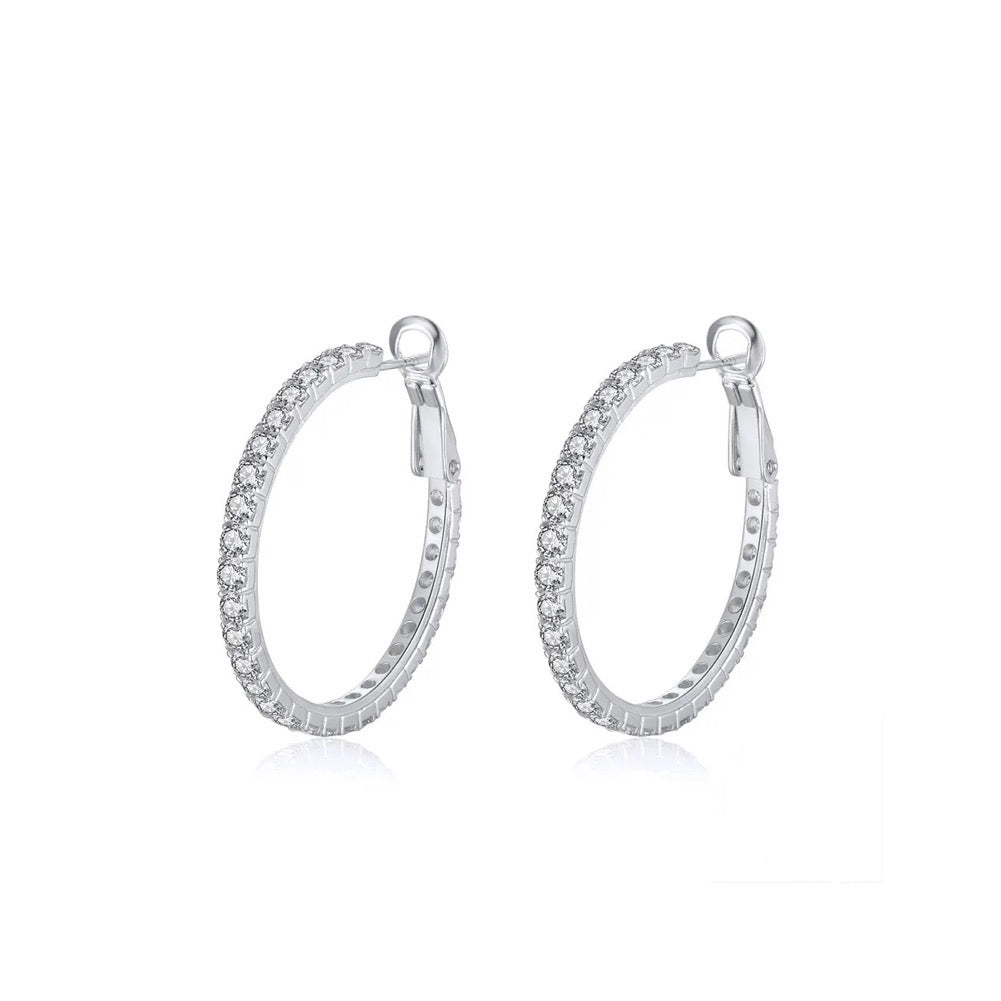 Earring hoops made of sterling silver with cubic zirconia stones. rhodium-plated. Pictured at a 45 degree angle with white background.