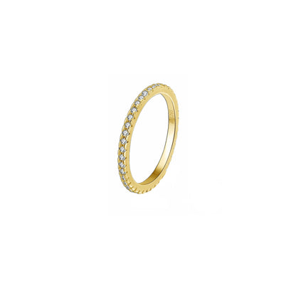 Sterling silver eternity band ring with 37 small cubic zirconia stones, 14K gold-plated. Pictured at a 45 degree angle, with white background.